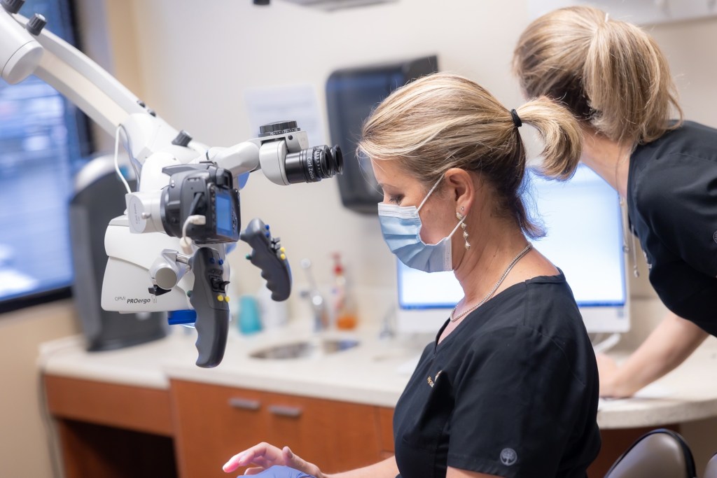 Woman assisting in dental operation